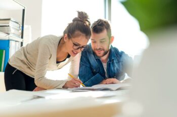 Man and Woman talking over some papers