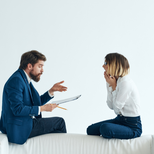 Two people talking over documents