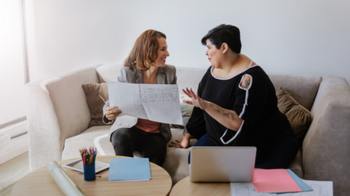 Two people talking over documents