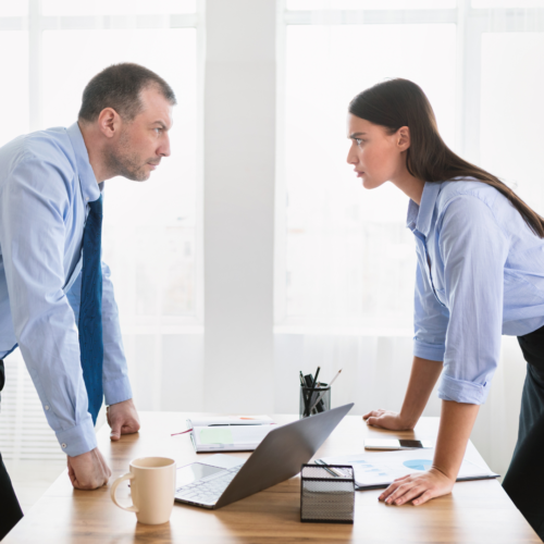 Two people standing over a desk