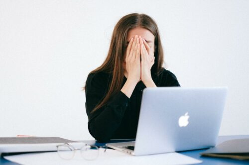Woman sad at her desk after experiencing quiet firing