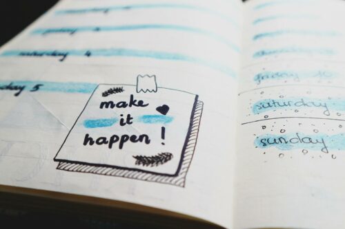 A planner with the words "make it happen" in bold