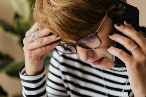 Anxious woman on the phone after hearing she may get a tax audit in 2023