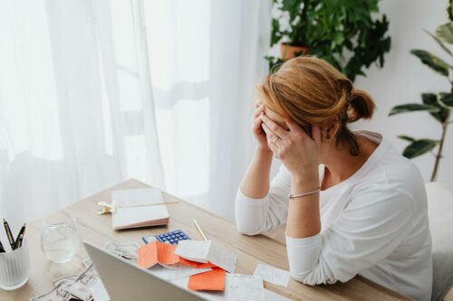 Woman looking at receipts to sort out tax documents and avoid a tax audit in 2023