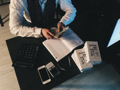 Man counting cash at desk after receiving great R&D tax advice