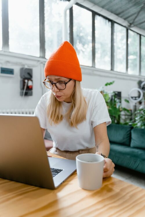 Woman on laptop, working out how to complete R&D Tax Credits 2023