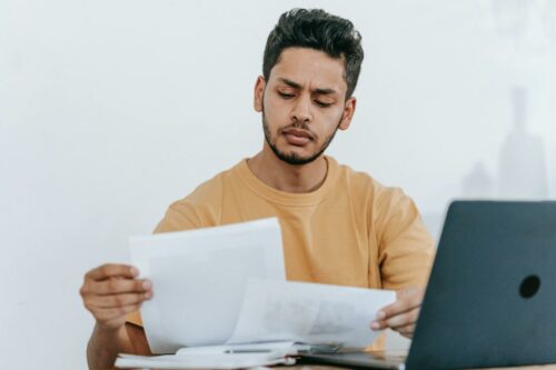 Man looking through documents to make sure everything's ready for his tax audit in 2023