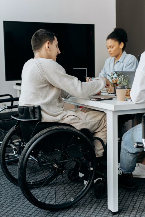 man sitting on a wheelchair while working on EMI schemes