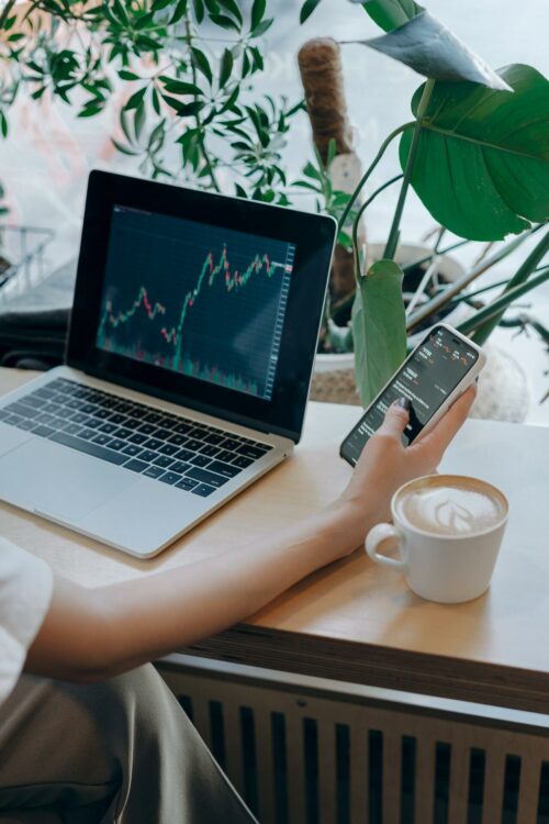 Business person Using Her Smartphone and Laptop
