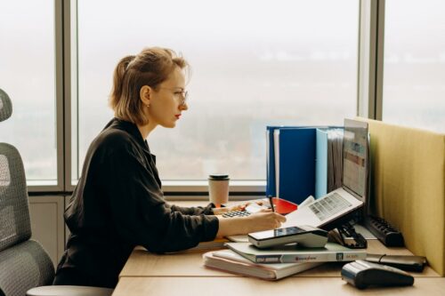 Woman in glasses concentrating on bookkeeping and accounting tasks