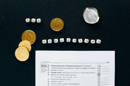 SME accounting tax sheet with gold coins lined up
