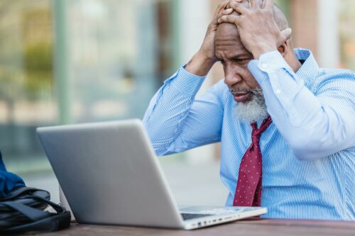 man confused on laptop wondering "what is capital gains allowance?"