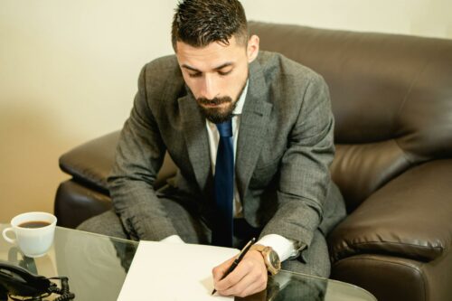 Man in suit making notes about angel investment network