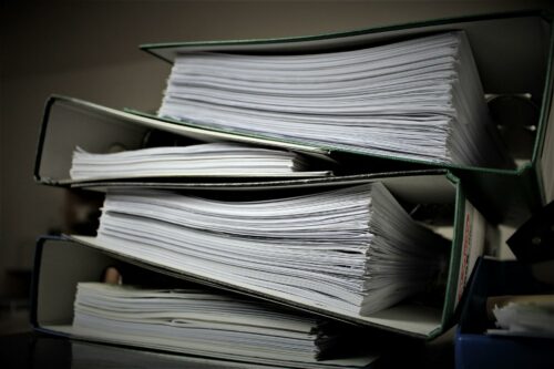 Extra large files filled with employer responsibilities - including national insurance for employers