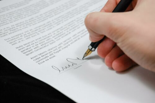 person signing a contract, before starting contract management automation