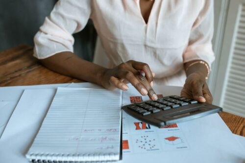 Woman calculating r&d changes at her desk