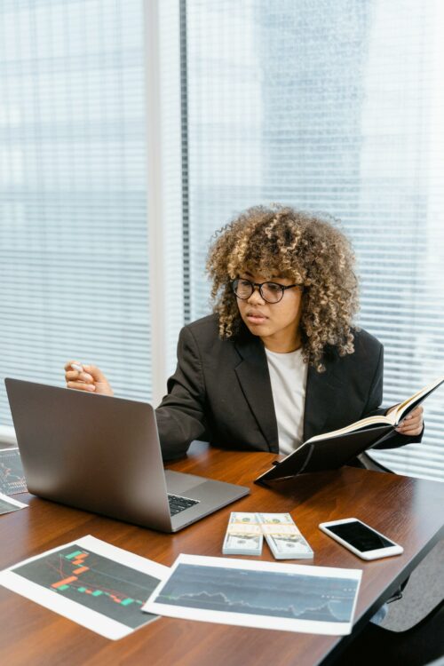 Woman on laptop concentrating on completing R&D Tax Credit 2023 paperwork